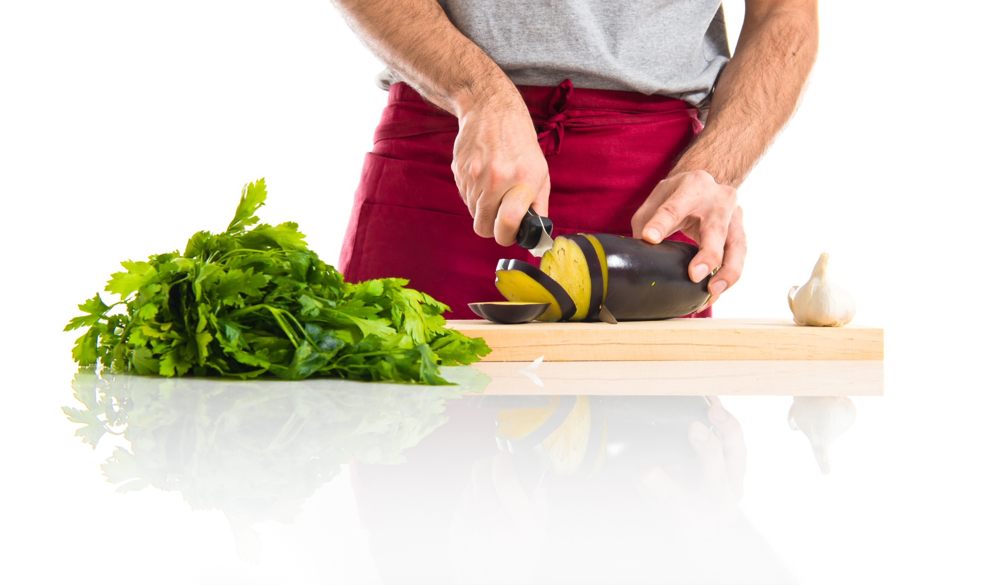 Chef preparing herbs on wooden board in studio